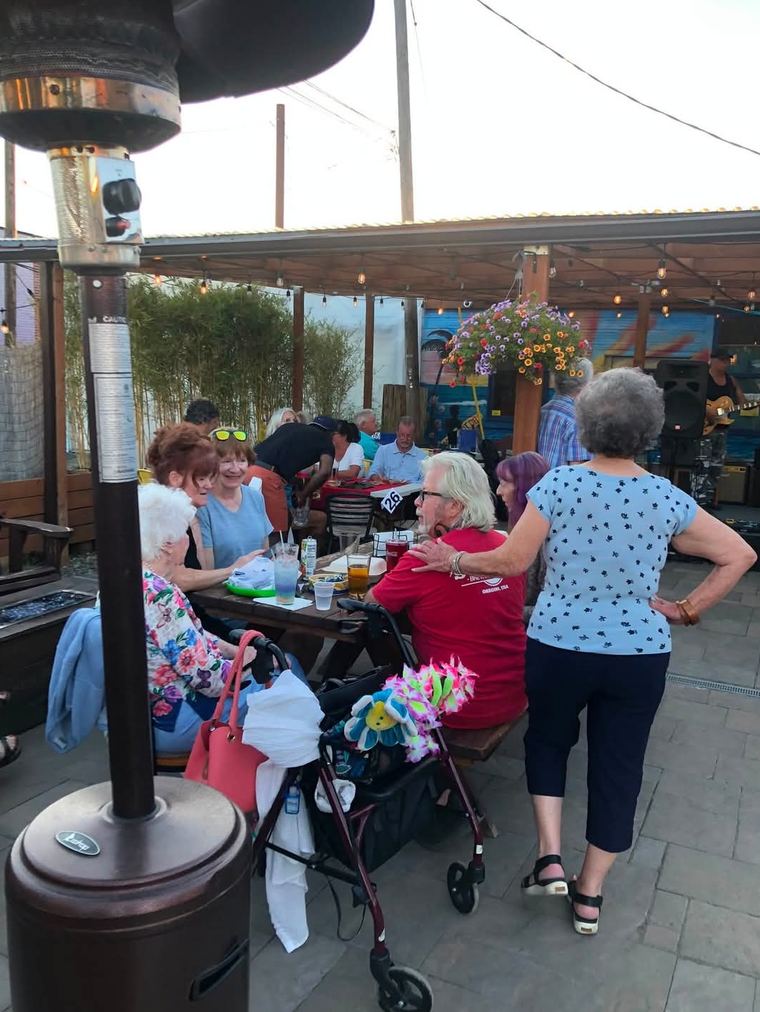 A summer crowd enjoying the music on the patio