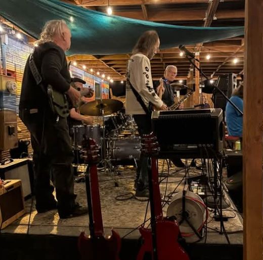 The band playing on the Beach Hut Deli patio at night
